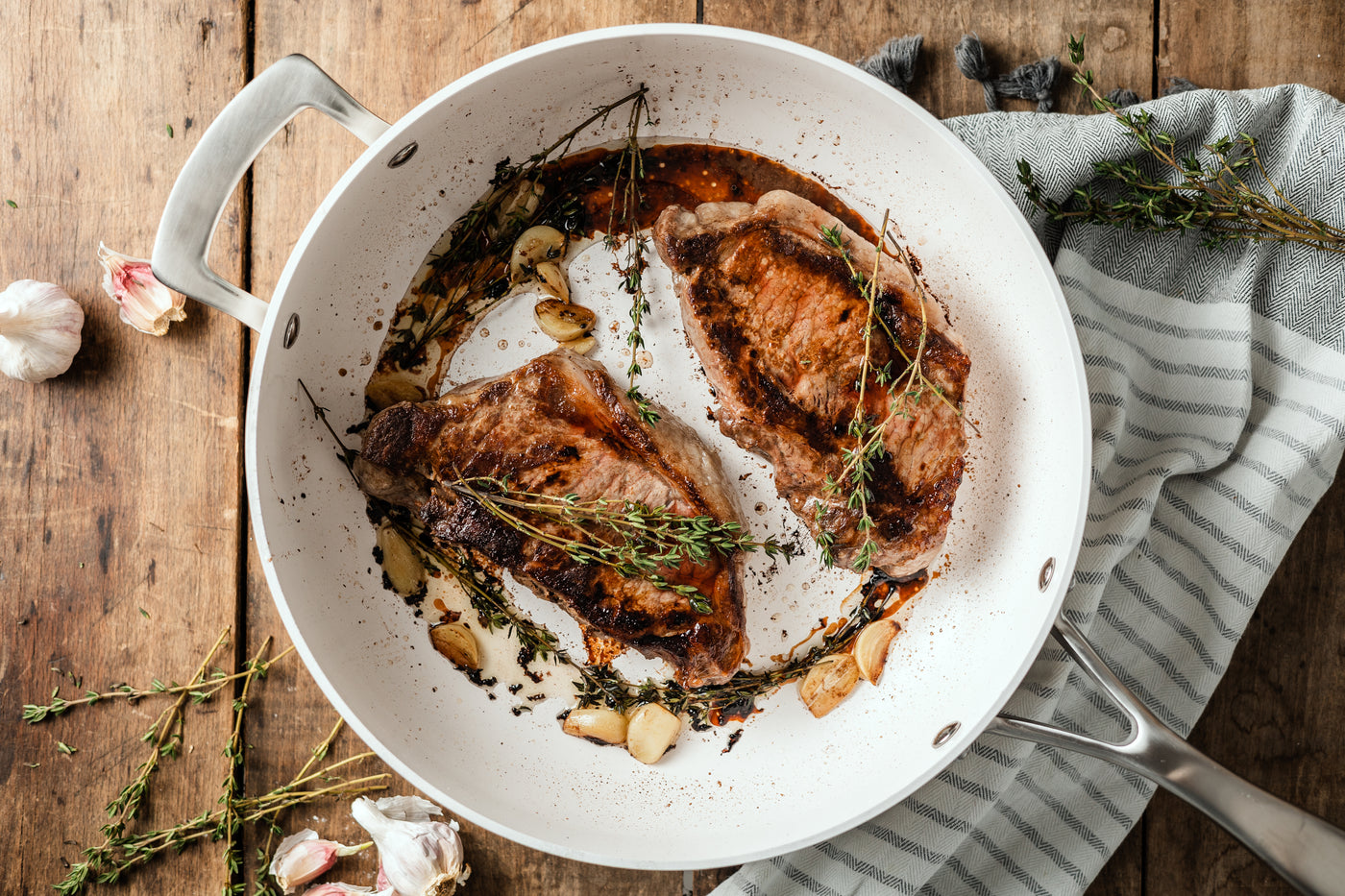 saute pan with steak on table