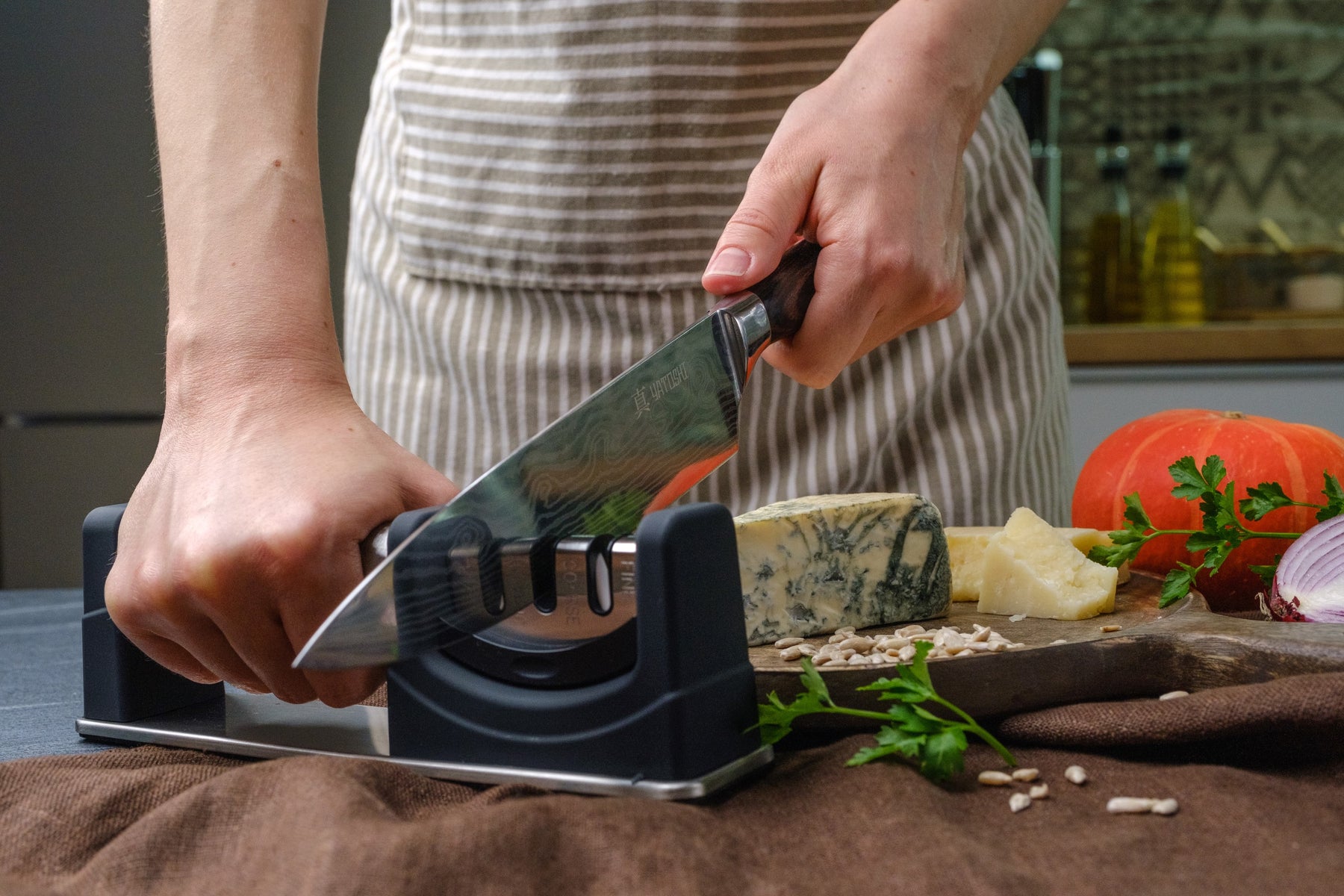 classic chef knife being sharpened by sharpener