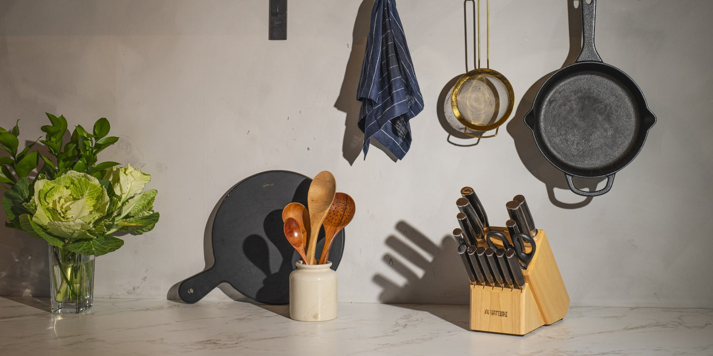 dark brown 15pc natural block set on kitchen counter with greenery and utensils
