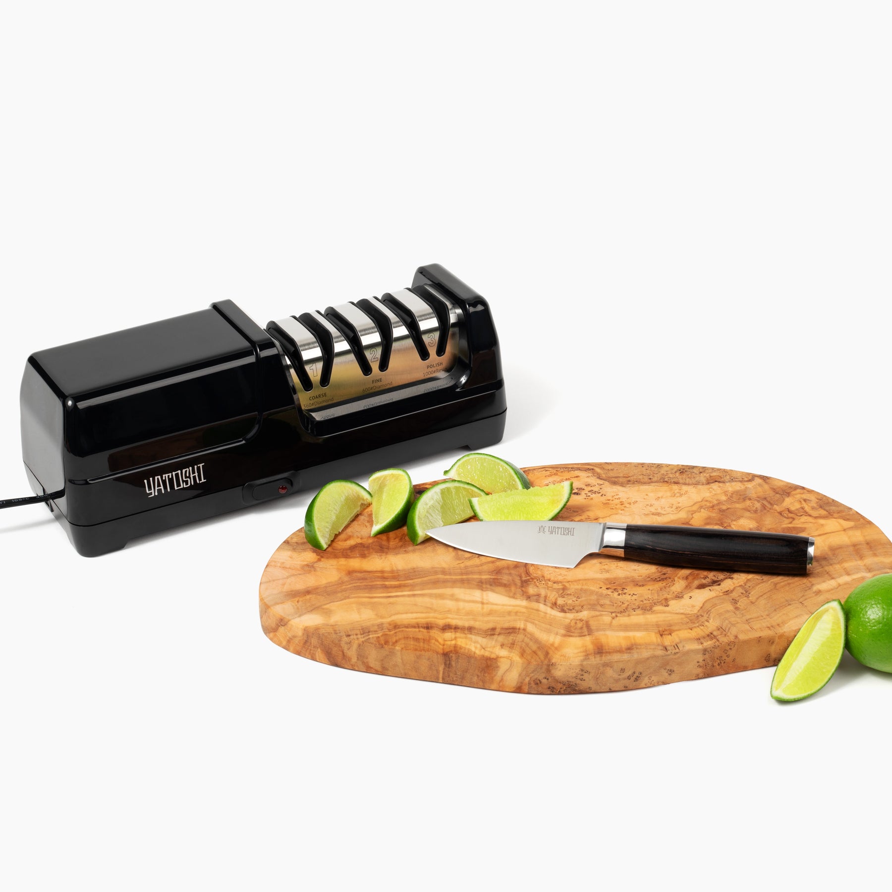 3 stage electric kitchen knife sharpener next to paring knife on cutting board with limes