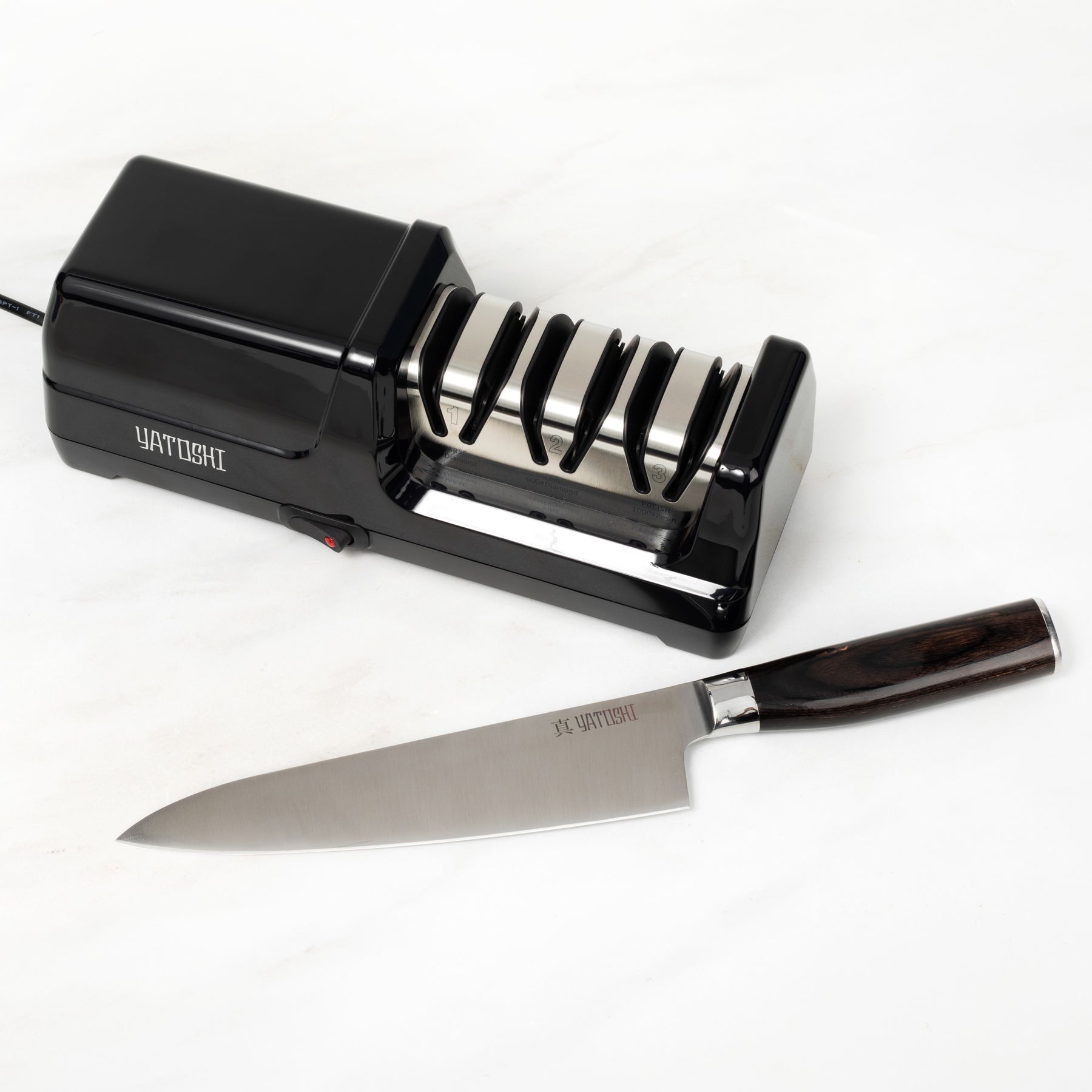 3 stage electric kitchen knife sharpener next to dark brown chef knife