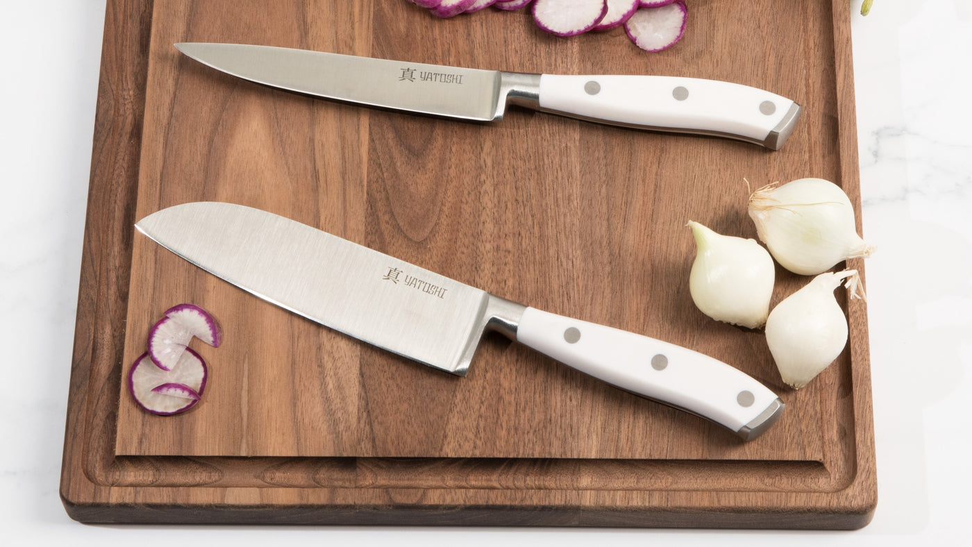 white abs santoku and utility knife on cutting board