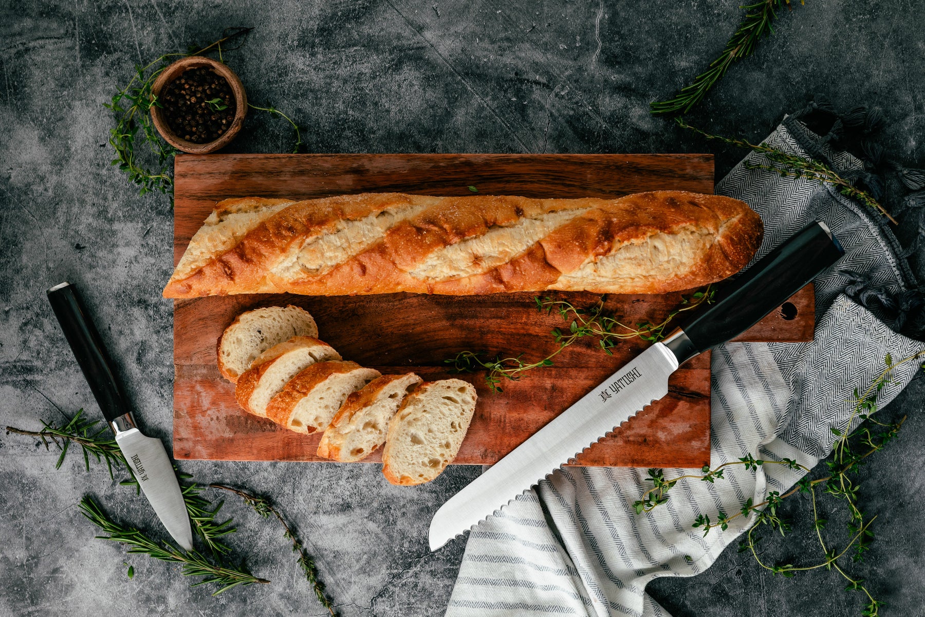 dark brown paring and bread knife with a loaf of bread